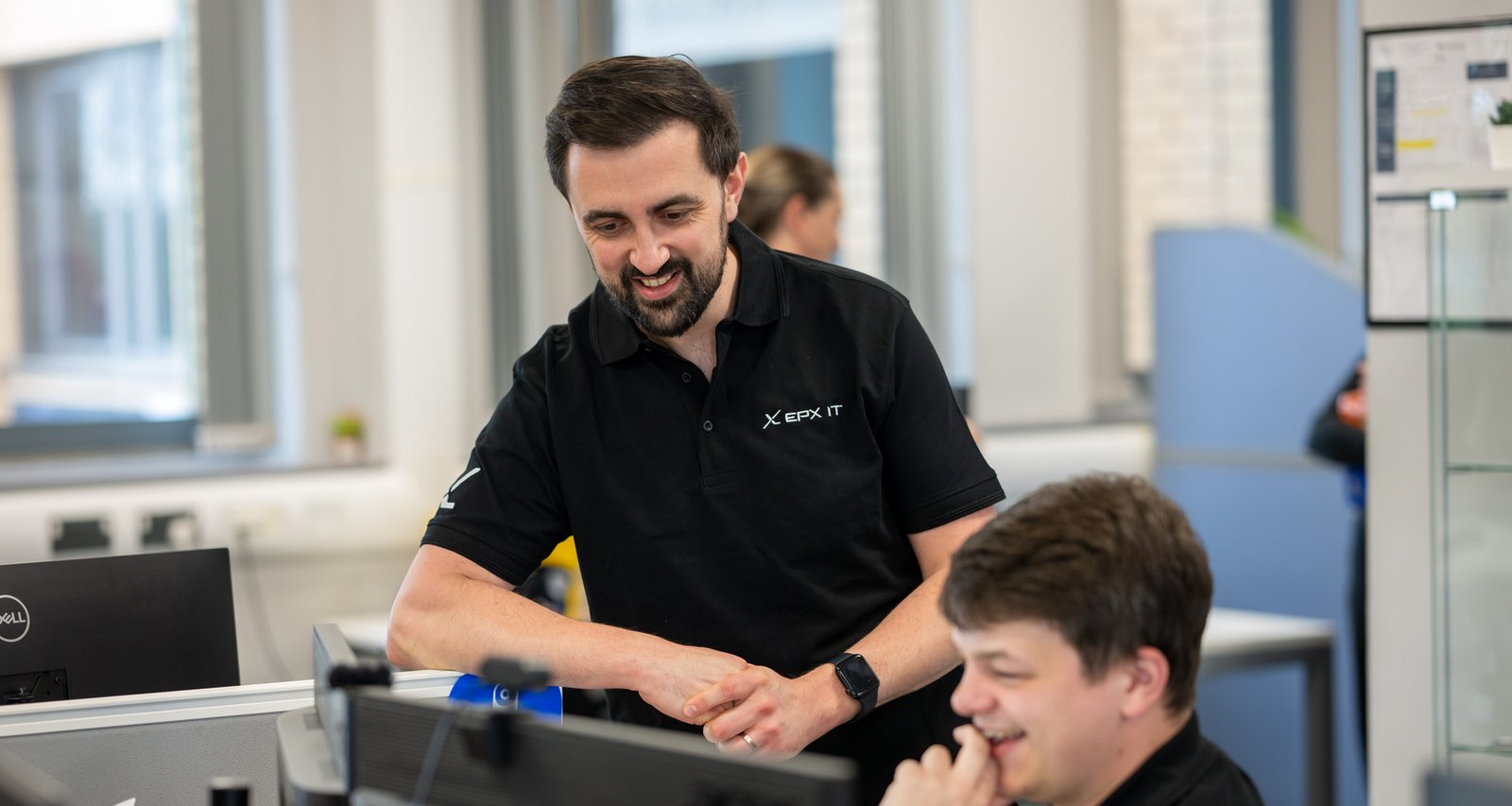 Two EPX IT engineers working together at a desk in the Stafford office